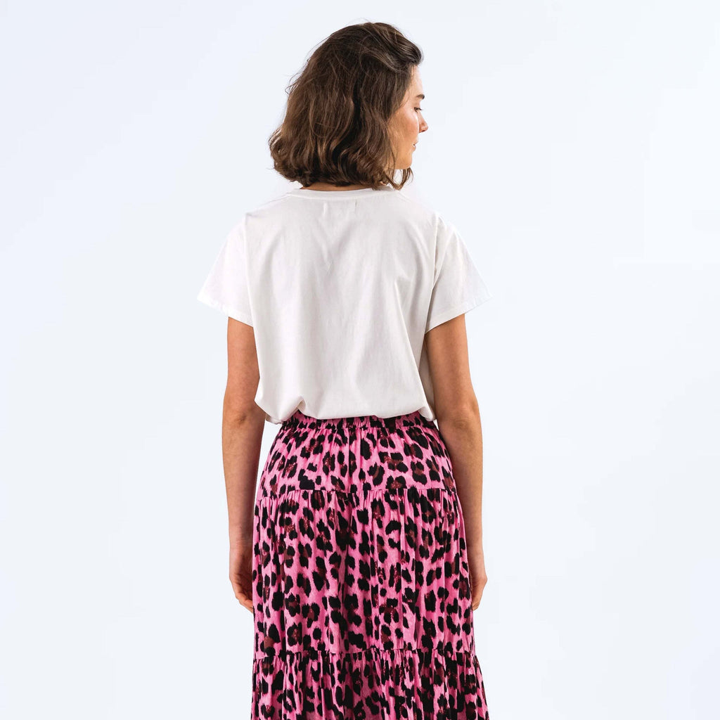 Back view of woman wearing Lollys Laundry White Roma T-Shirt with colorful cat graphic design.